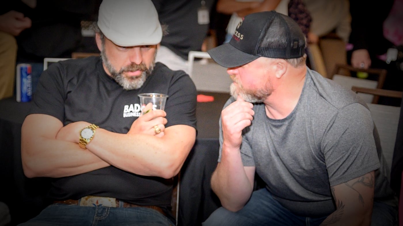 Two attendees in conversation at the Badass Business Summit happy hour